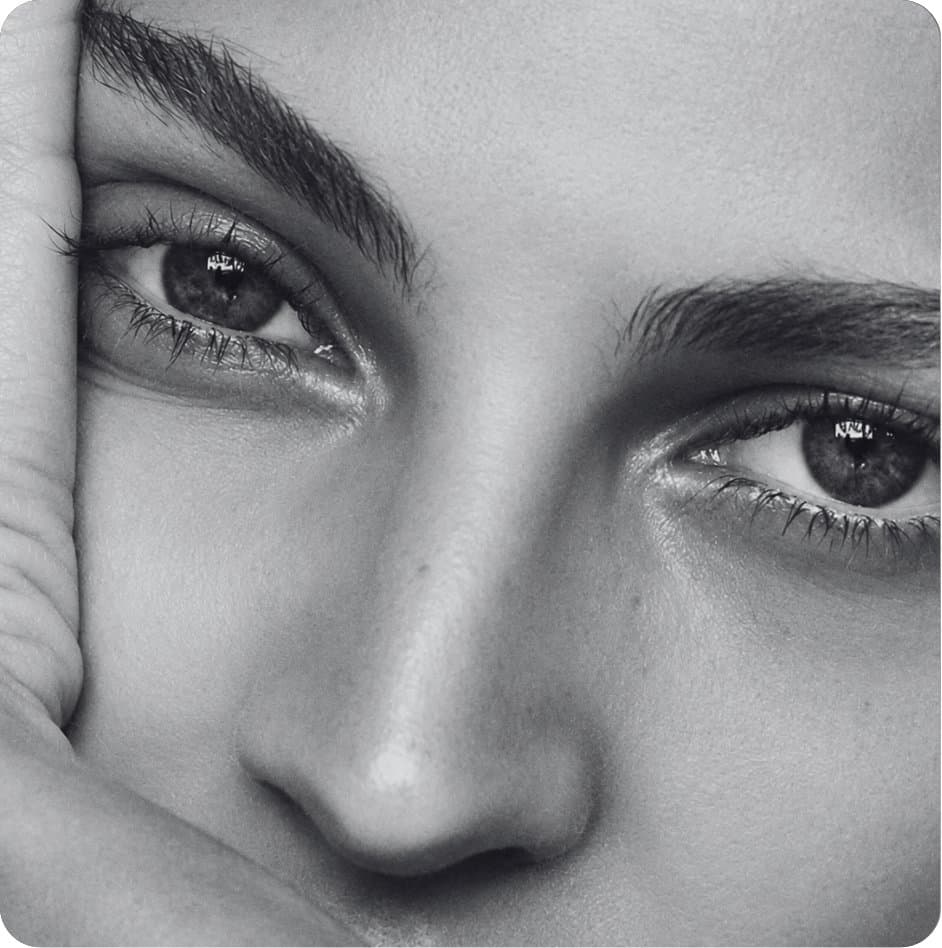 A close-up black and white portrait of a woman’s eyes
