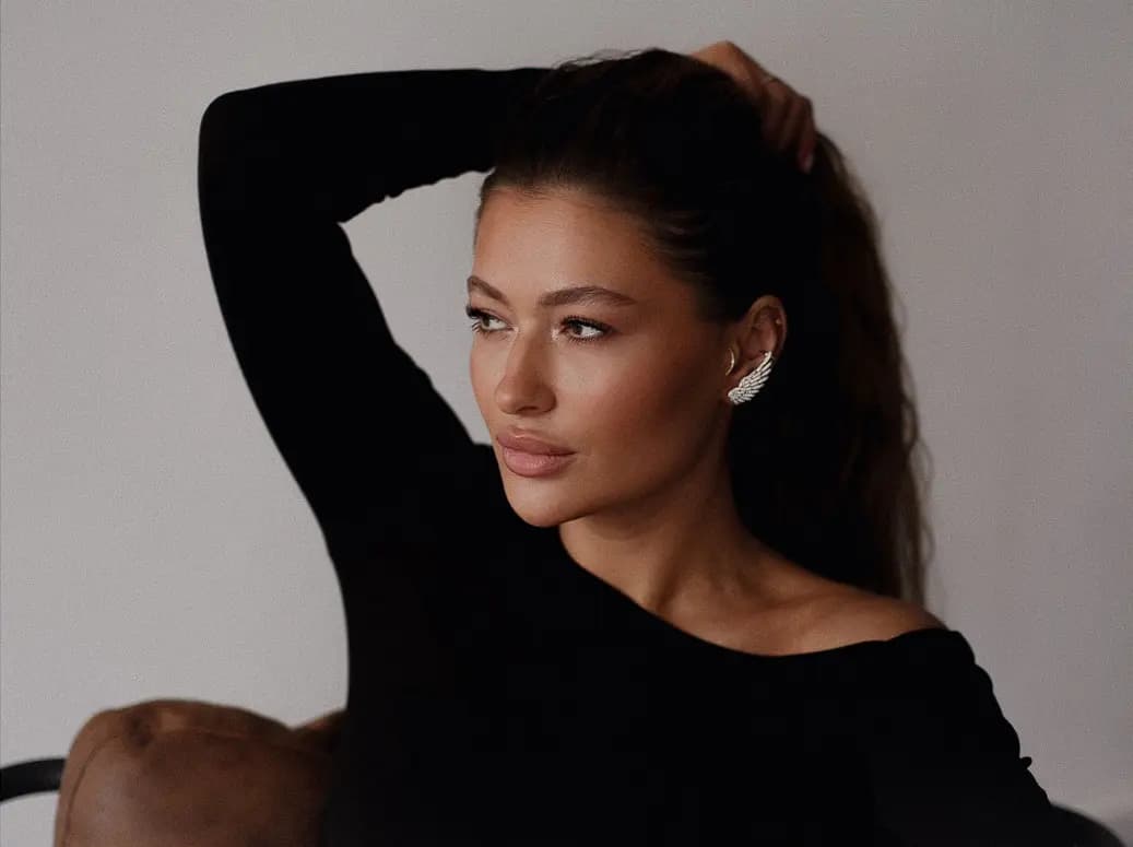 A woman in a black off-shoulder top