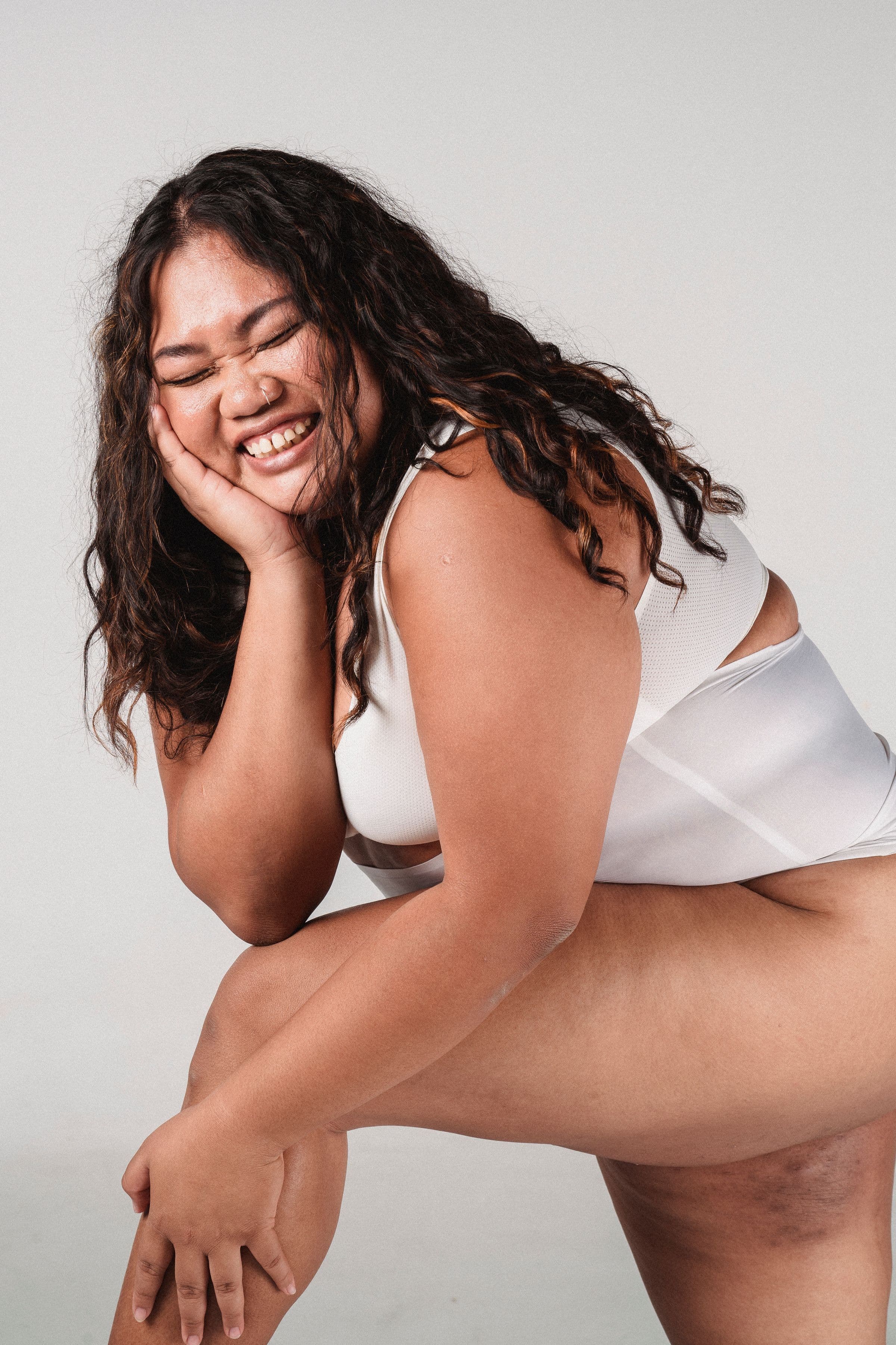 A smiling woman standing confidently, opening an honest look at whether lipo-C, MIC and B12 injections work for weight loss