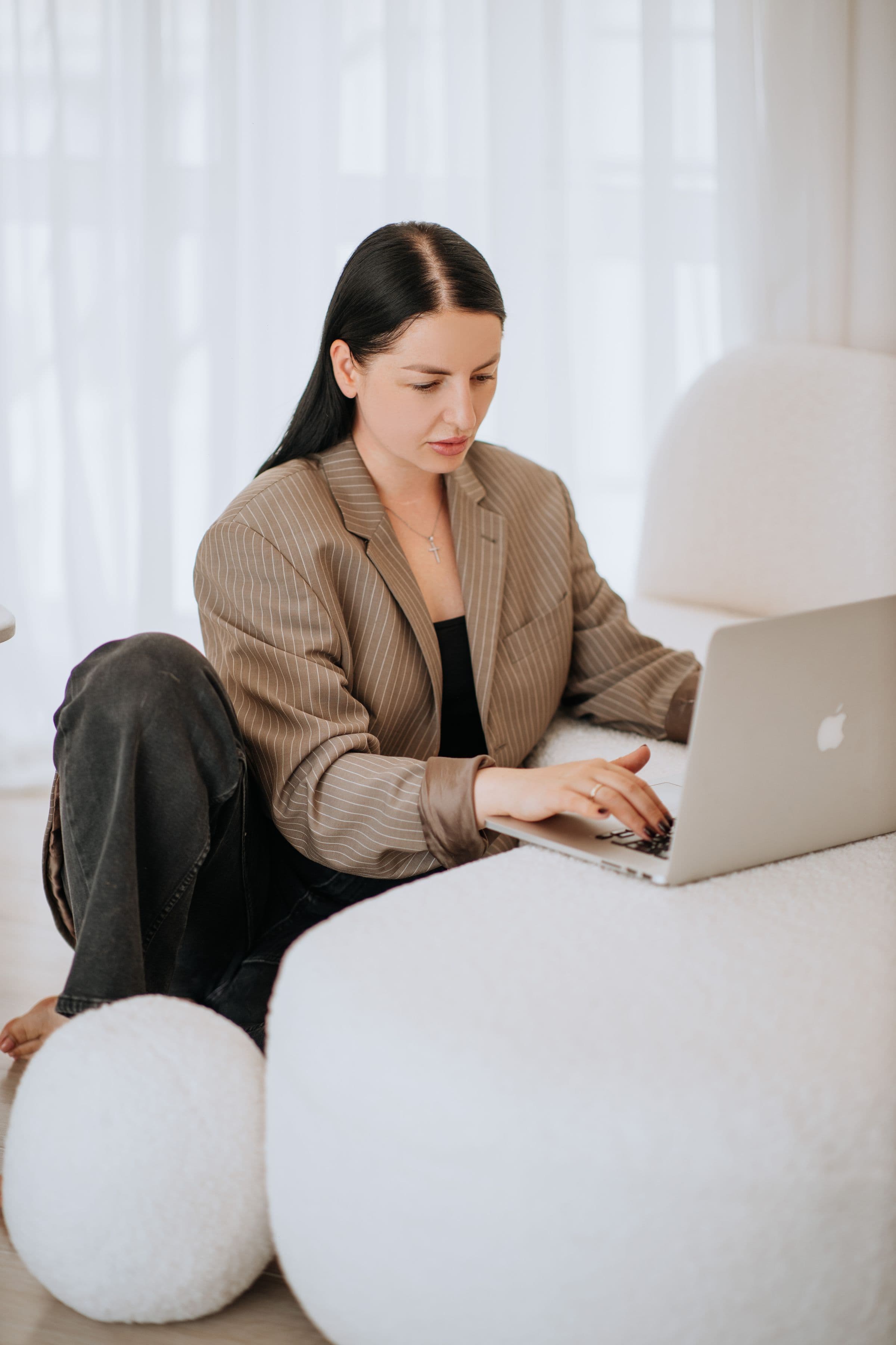 A woman working on a laptop at home, the way an online visit to get semaglutide prescribed begins