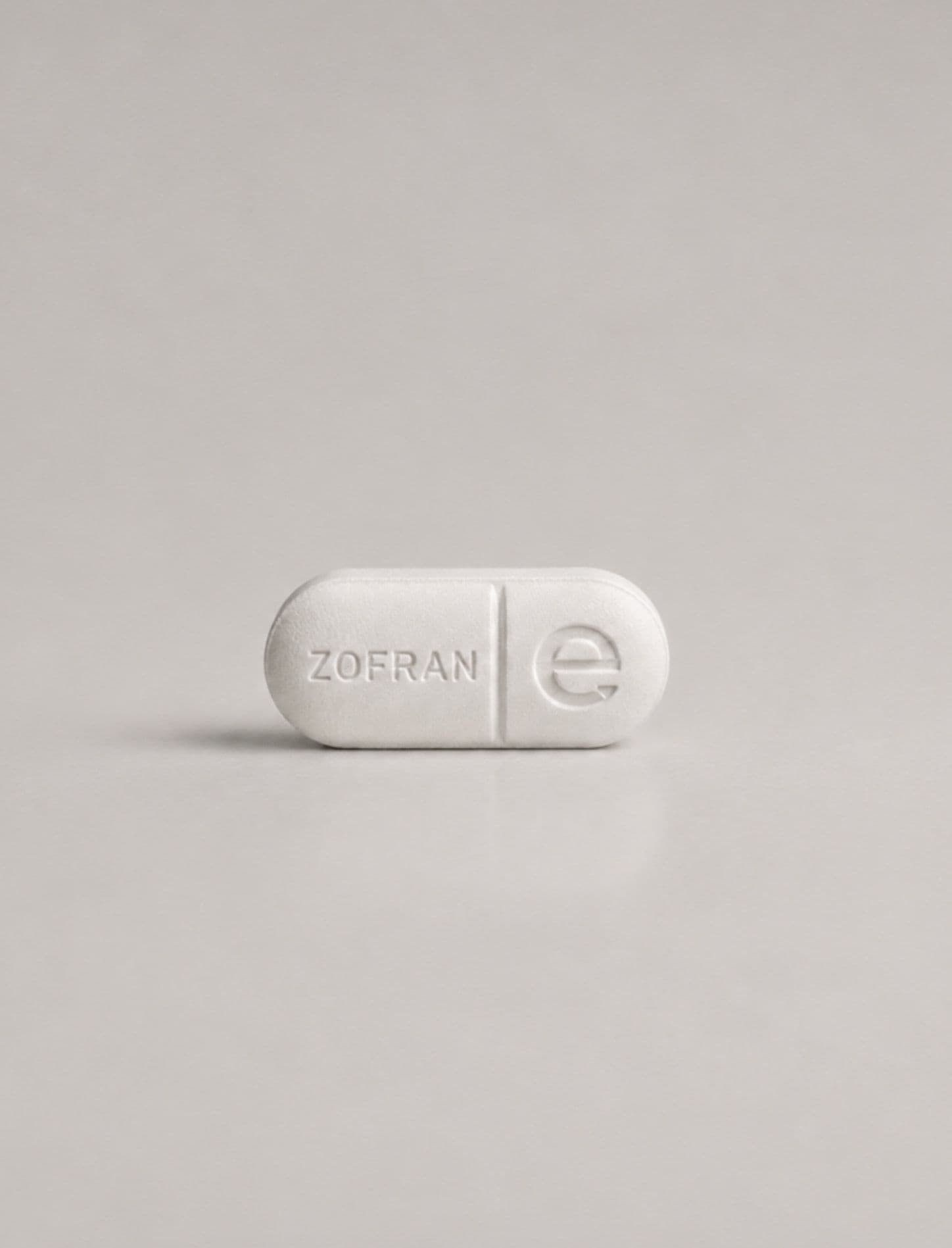 A single white Zofran tablet embossed with the Elara e
