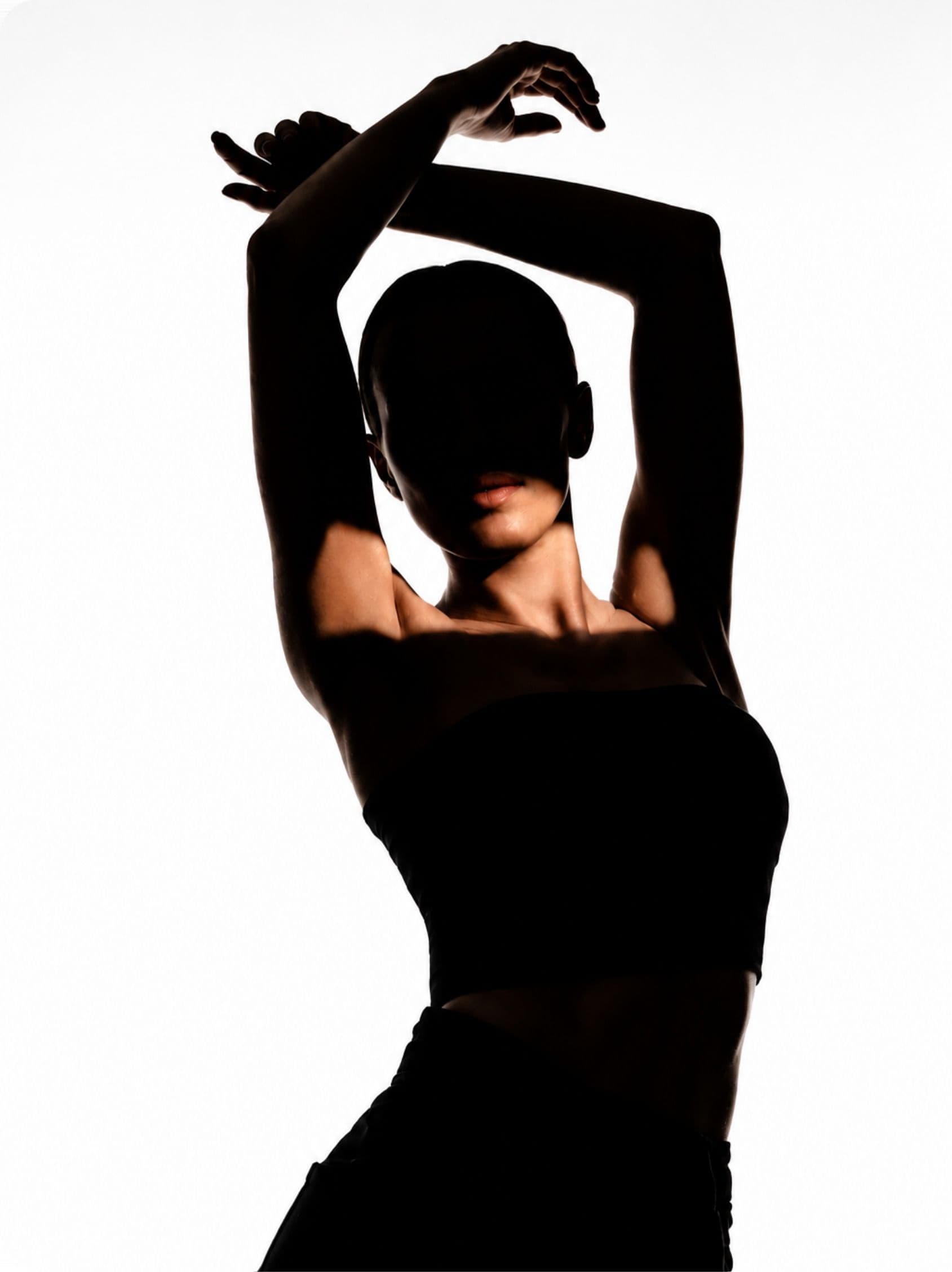 A woman in silhouette, arms raised