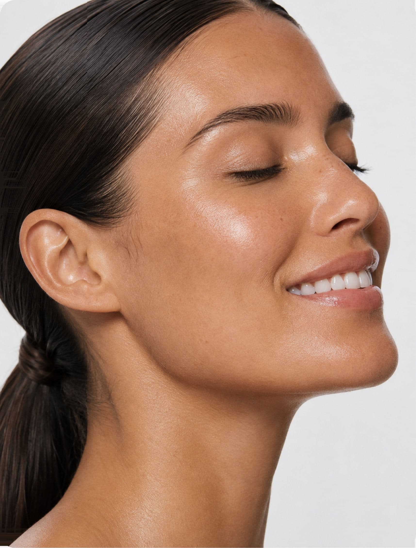 A woman smiling with her eyes closed