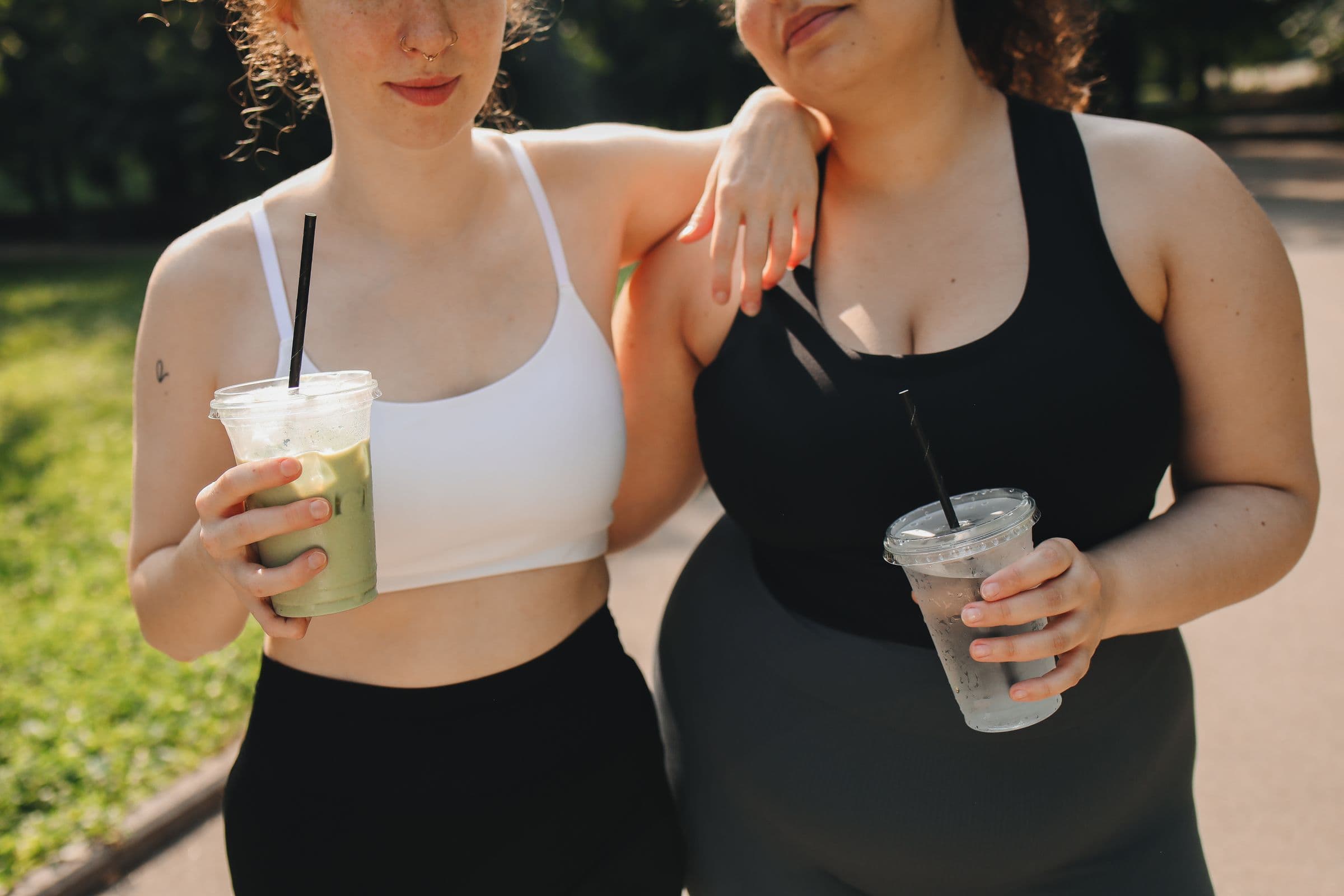 Two women in activewear with iced drinks, opening a guide to semaglutide sulfur burps and how to stop them