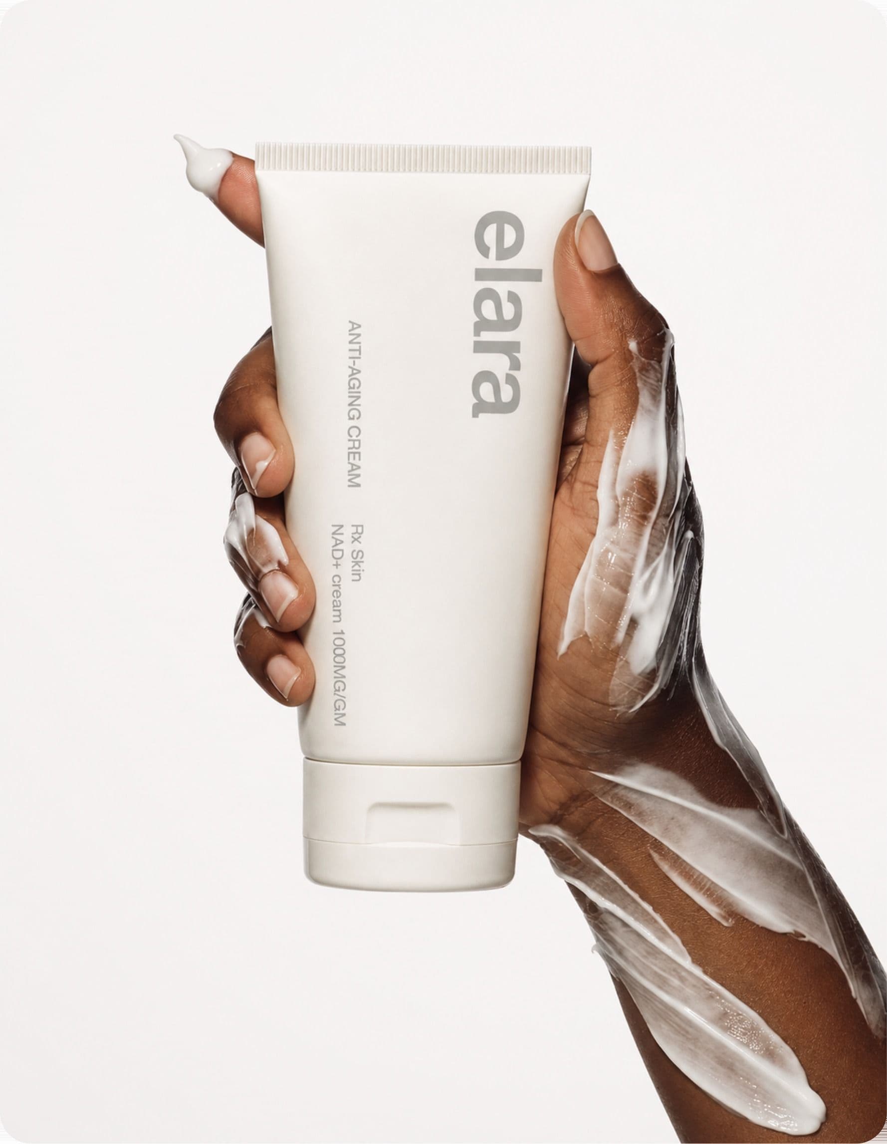 A hand holding the elara NAD+ cream tube