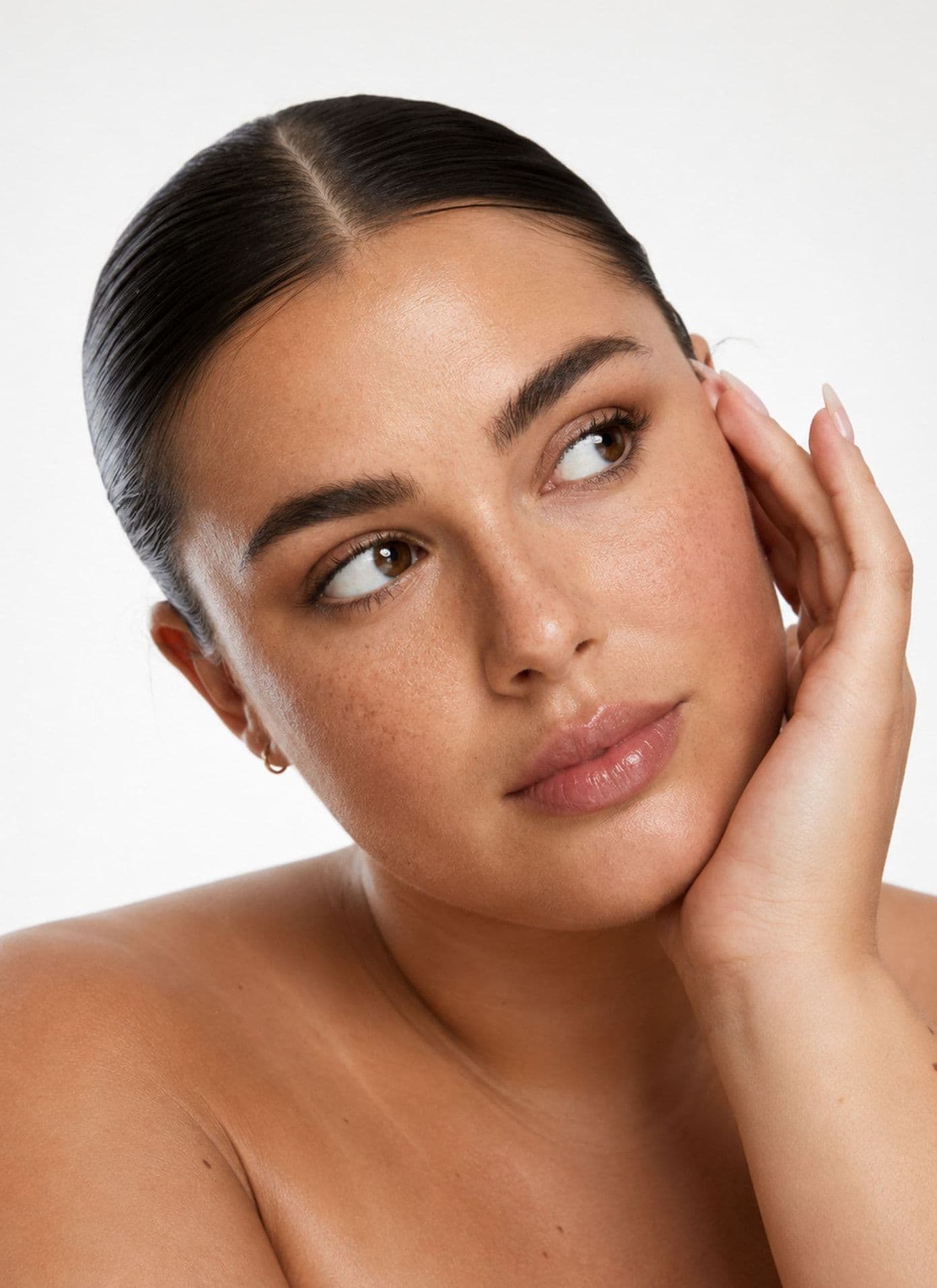 A woman resting her hand against her face