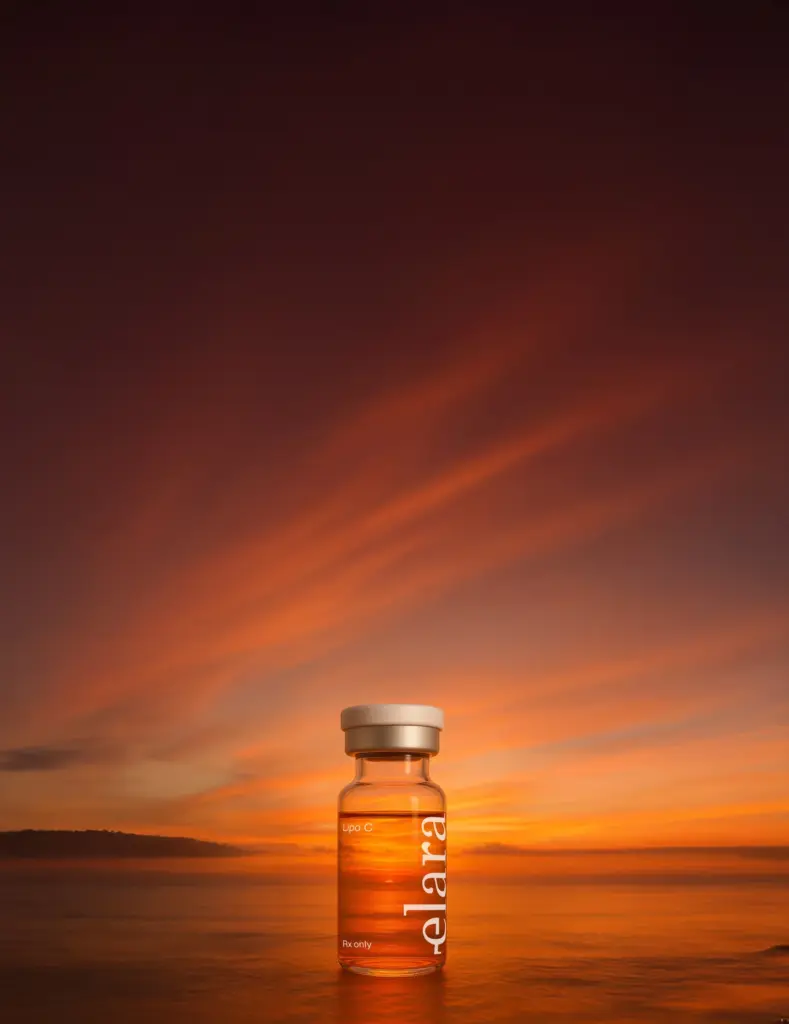 Elara Lipo-c compounded injectable vial placed on a reflective water surface